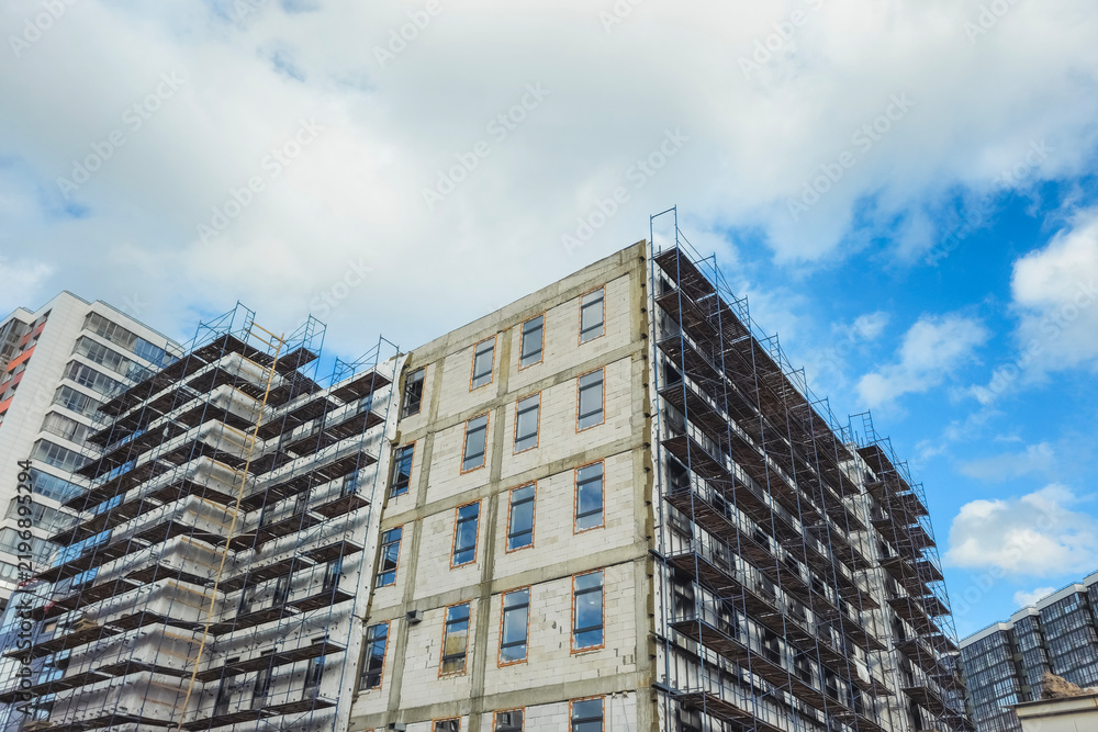 Fototapeta premium Primary real estate market concept with modern residential apartment building under construction