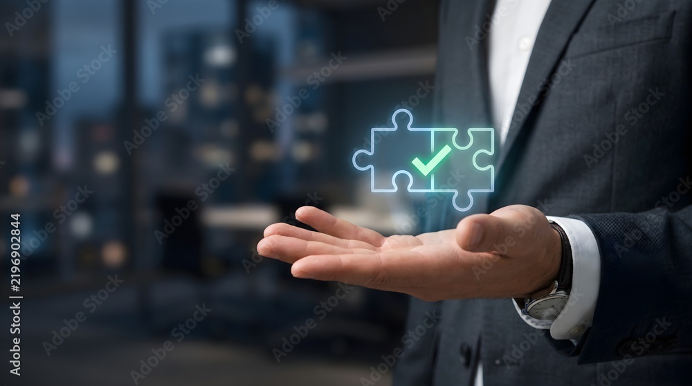 Obraz premium Puzzle Pieces with Verified Checkmark Hologram, Held by Businessman