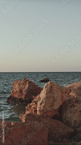 Rugged Rocky Cliff Rising Above Clear Blue Ocean Water