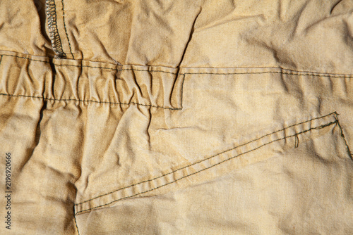 Bild auf Leinwand Close-up of vintage cotton crumpled canvas fabric focusing on constructive seams and stitching details