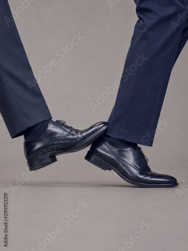 Businessmen in formal shoes tripping each other, concept for corporate rivalry, workplace competition, sabotage and professional conflict