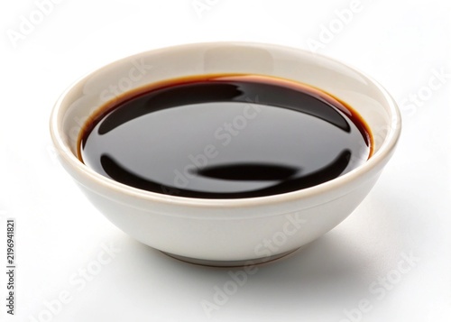 soy sauce in white bowl close up on white background