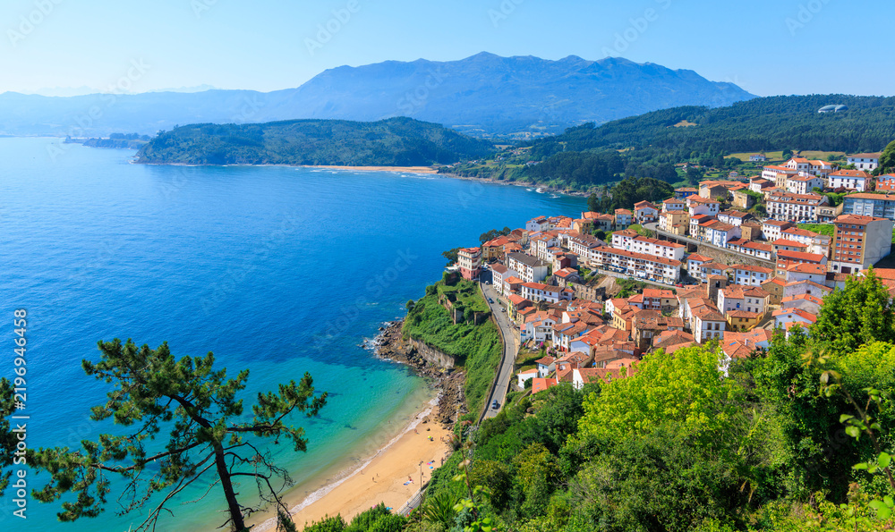 Obraz premium Panoramic view of coastal fishing village lastres in asturias spain under blue sky
