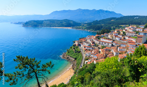 Panoramic view of coastal fishing village lastres in asturias spain under blue sky