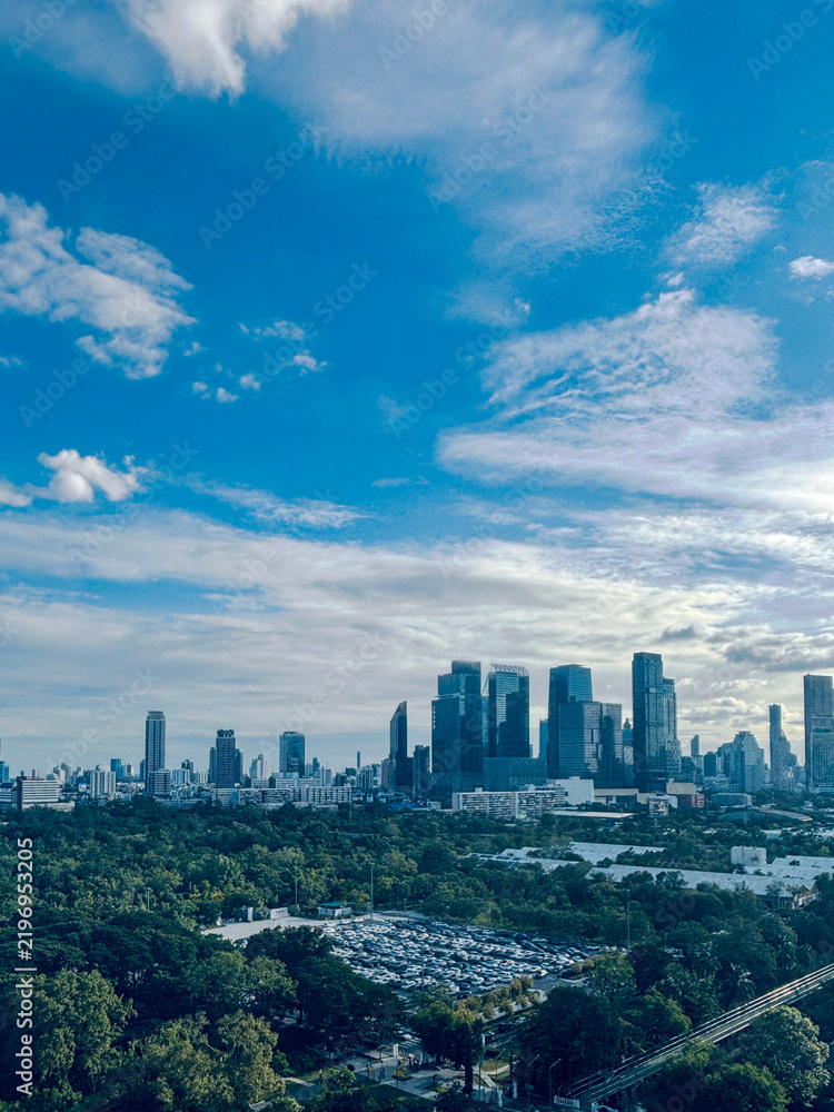 Fototapeta premium Aerial perspective of Benjakiti Park forest park surrounded by high-rise buildings in Bangkok
