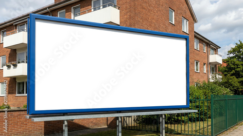 Blank white advertising banner mounted on the fence against office building