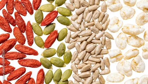 Fotografie Dried goji berries green pumpkin seeds sunflower seeds and puffed rice, isolated