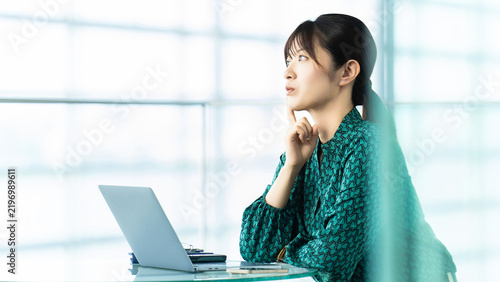                                                                                       Businesswoman Thinking While Using a Laptop