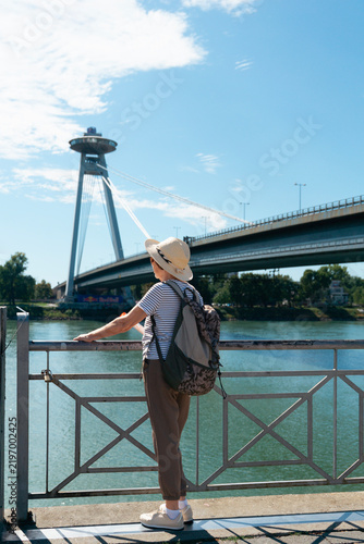 Photography elderly tourist woman looking at SNP bridge in Bratislava Slovakia landscape bac