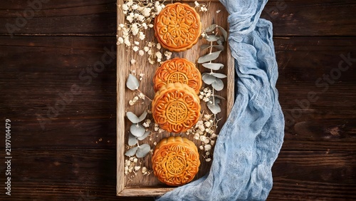 Mooncakes on wooden tray with flowers