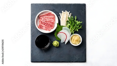 Raw meat and accompaniments on slate