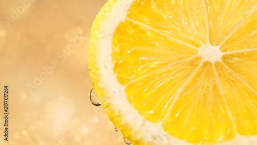 Half lemon slice with water droplets