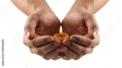 Cupped hands holding burning candle, glowing flame in palms of male hands, spiritual prayer and hope concept on white background