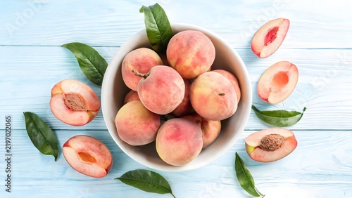 Peaches in a bowl with leaves