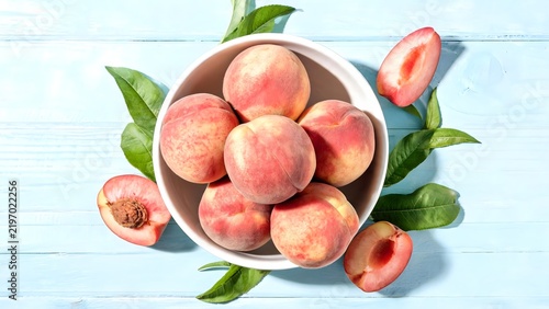 Peaches in a bowl with leaves