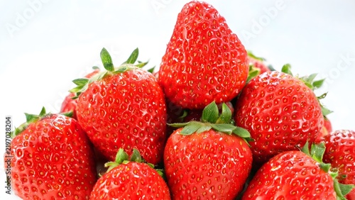 Fresh red strawberries with green leaves
