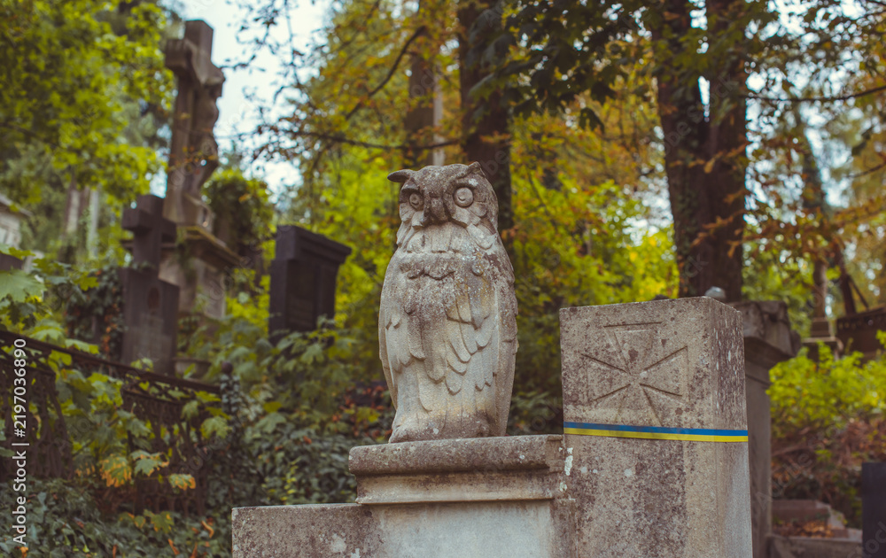 Fototapeta premium Ancient European cemetery with stone angels and historic tombstones