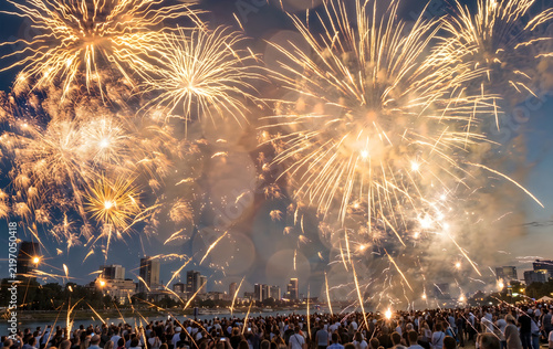 Golden fireworks exploding over crowd at night