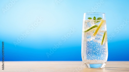 Refreshing sparkling water in a clear elegant glass with ice