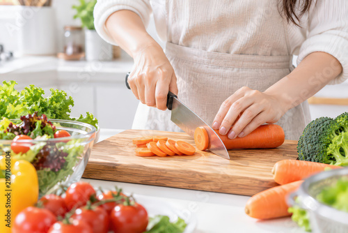 Carrot knife cutting board kitchen vegetable prep with fresh produce on counter