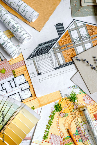 Residential house blueprint with floor plans, landscape design, color swatches and material samples, concept of sustainable architecture, home renovation and construction planning.