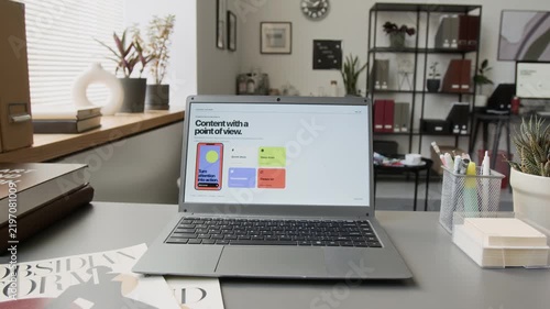 Modern laptop displaying responsive digital interface standing on desk during camera pan. Visual asset perfect for tech commercials, website mockups, SaaS branding, and online marketing tutorials