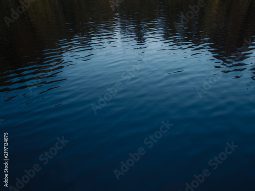Aerial view of the dark, rippling waters of Lake Nasijarvi reflecting the surrounding landscape in Tampere, Pirkanmaa, Finland.