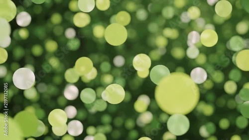 Abstract background of soft, out-of-focus green and white circles, evoking a sense of nature and tranquility.