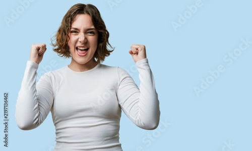 фотографія Woman casual, excited and proud, screaming with raised arms, celebrating success