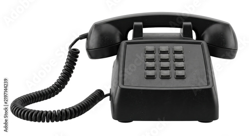Foto Classic black push-button telephone with a coiled cord and handset rests on a cl