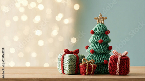 Knitted Christmas tree with handmade wrapped gift beside warm holiday lights and festive ornaments creating cozy seasonal display on wooden table