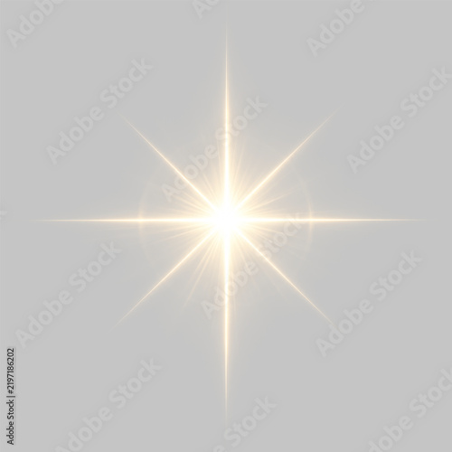 A brilliant golden starburst shines brightly on a black background with symmetrical rays radiating outward. Its glowing light and subtle halos create a dramatic and luminous effect.