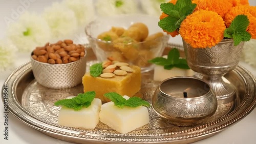 Govardhan Puja street scenes Traditional sweets and flowers on a silver tray. Hindu rituals with cow and mountain symbols Festive offerings during Indian religious ... See More