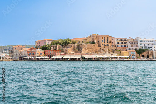 The historic Kastelli Hill at the Old Venetian Harbor of Chania in Crete, Greece, with waterfront restaurants in summer.