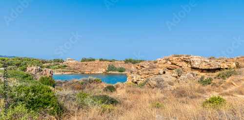 Scenic cove at Agii Apostoli beach near Chania in Crete, Greece, featuring calm turquoise sea and sandy beach in summer.