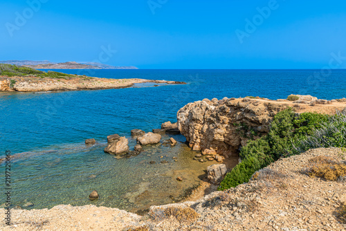 Scenic cove at Agii Apostoli beach near Chania in Crete, Greece, featuring calm turquoise sea and sandy beach in summer.