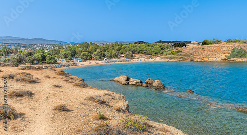 Scenic cove at Agii Apostoli beach near Chania in Crete, Greece, featuring calm turquoise sea and sandy beach in summer.