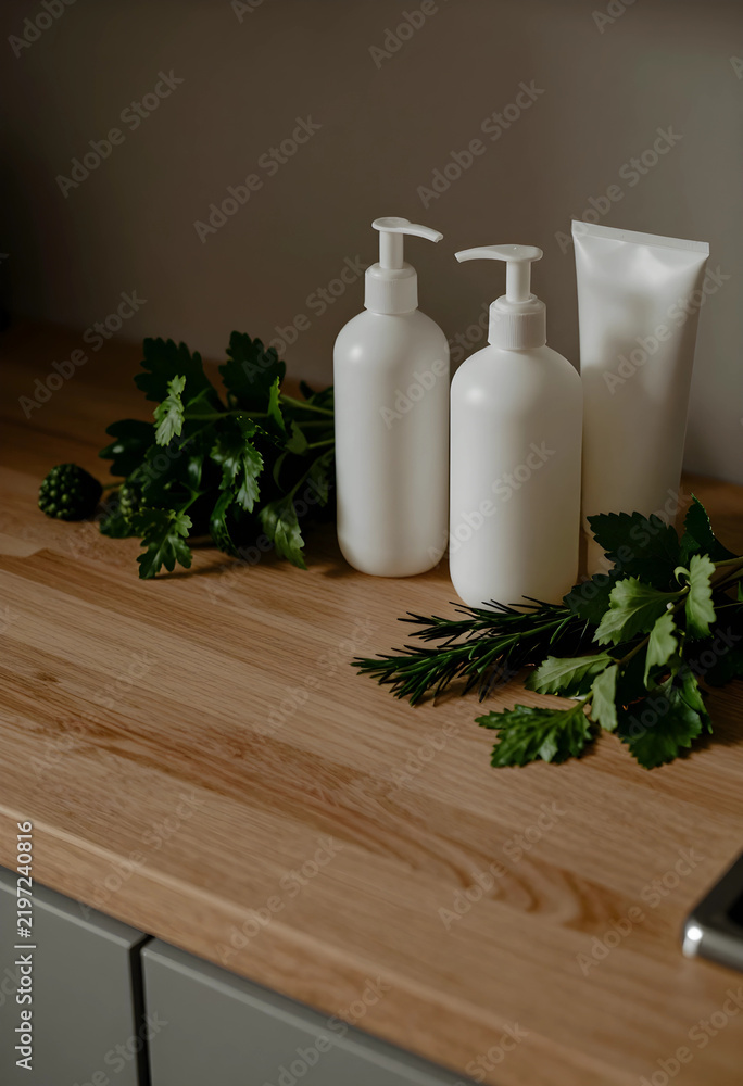 Obraz premium Organic skincare and natural beauty products, white cosmetic bottles with fresh herbs on wooden kitchen counter for sustainable wellness and spa routine