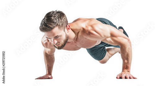 Muscular man performing push ups against a white background for fitness