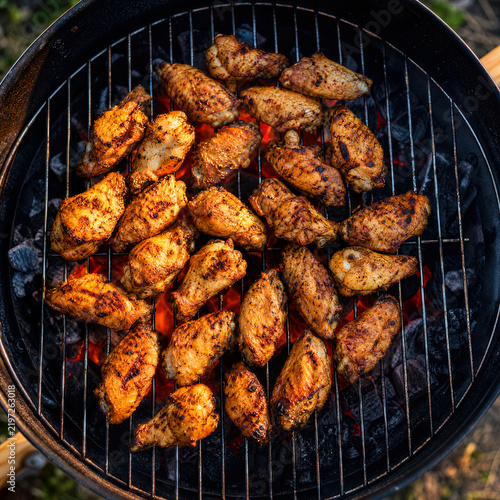 BBQ chicken wings cooking on an outdoor grill