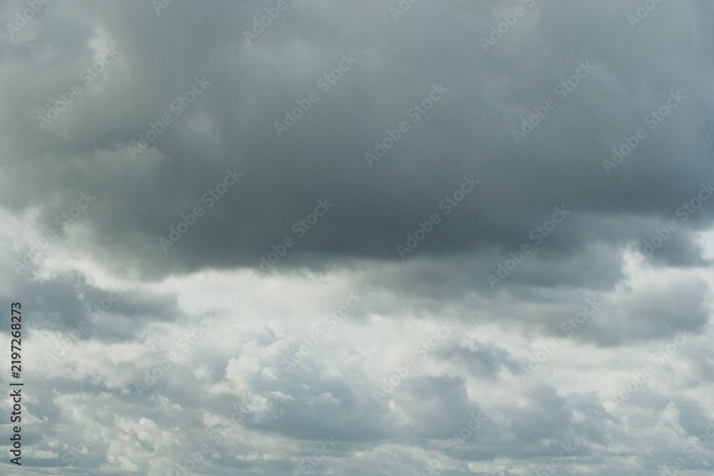 Fototapeta premium Dramatic cumonimbus cloud in the blue sky before a heavy rain storm. Huge fluffy textured cloudscape backdrop, powerful meteorology environment and weather forecast concept. Majestic natural scenery. 