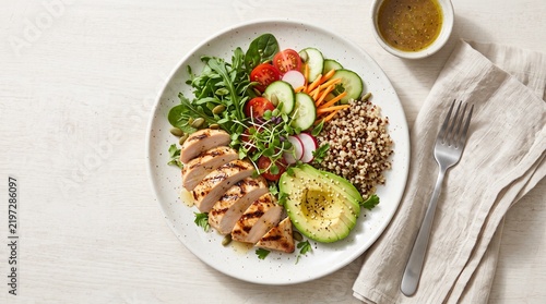 Wholesome and Flavorful Grilled Chicken Power Bowl with Quinoa, Avocado, and a Medley of Fresh Garden Vegetables for a Balanced Meal