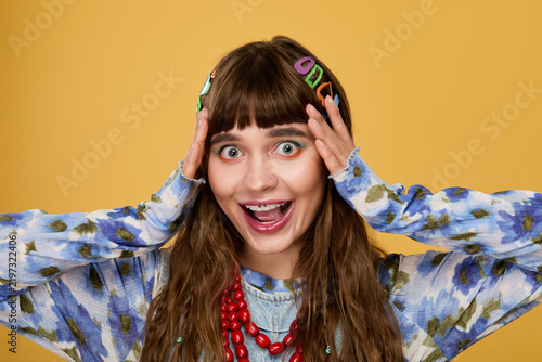 Принти на полотні Cheerful woman in vibrant fashion enjoying a moment of bliss