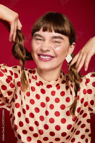 Quadro su tela Vibrant woman enjoys playful moment in colorful clothing