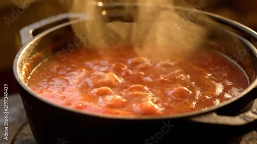 Thick Soup Boiling and Steaming in Black Cooking Pot. 4K Video