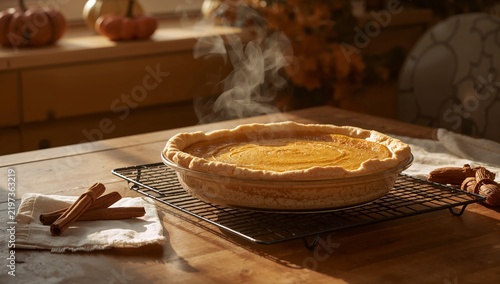 Freshly Baked Pumpkin Pie With Steam Rising in a Cozy Kitchen
