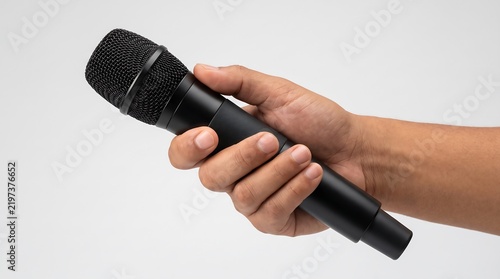 Hand holding a wireless microphone isolated against a clean white background