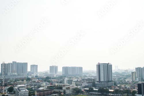 Hazy city skyline in Malaysia, representing transboundary haze, air pollution, poor air quality, environmental issues, reduced visibility, and regional pollution.