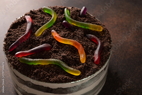Konstfotografi Homemade Halloween dirt cake topped with chocolate cookie crumbs and colorful gummy worms resembling worms crawling in soil