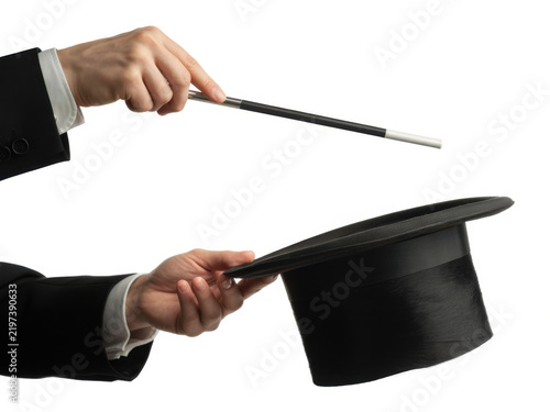 Magician holding a wand over a top hat for a magic trick performance